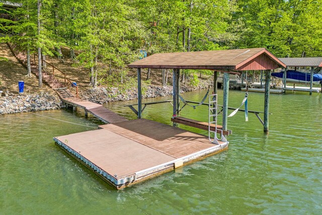 dock area with a water view and a forest view