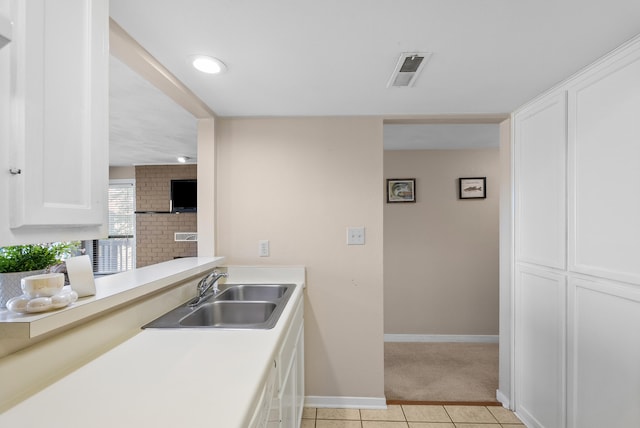 75 Dockside Cir Unit 308, Moneta, VA 24121 - kitchen with white cabinets, light colored carpet, a sink, light tile patterned floors, and visible vents