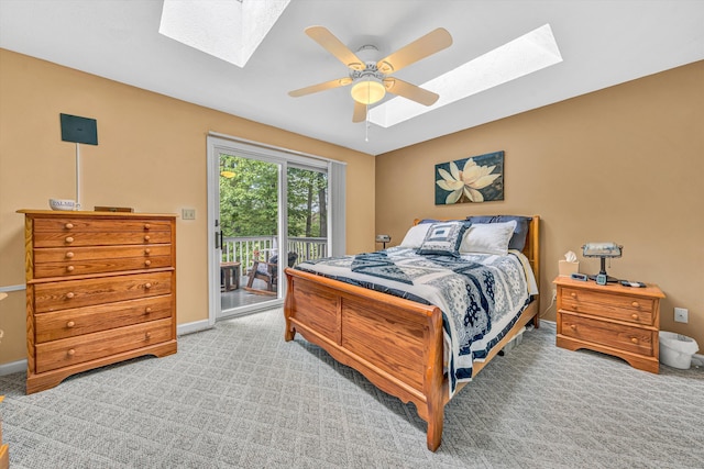 bedroom featuring a skylight, light carpet, and access to exterior