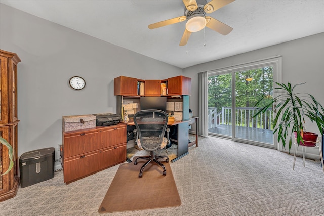 home office featuring ceiling fan, light carpet, and vaulted ceiling