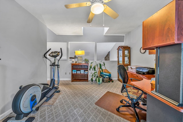 carpeted home office featuring a ceiling fan and baseboards