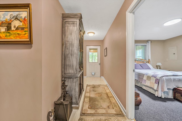 corridor with baseboards and a textured ceiling