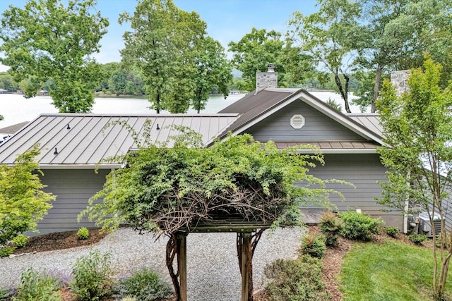 511 Autumn Ave, Huddleston, VA 24104 - view of front facade featuring a standing seam roof, metal roof, a chimney, and central air condition unit