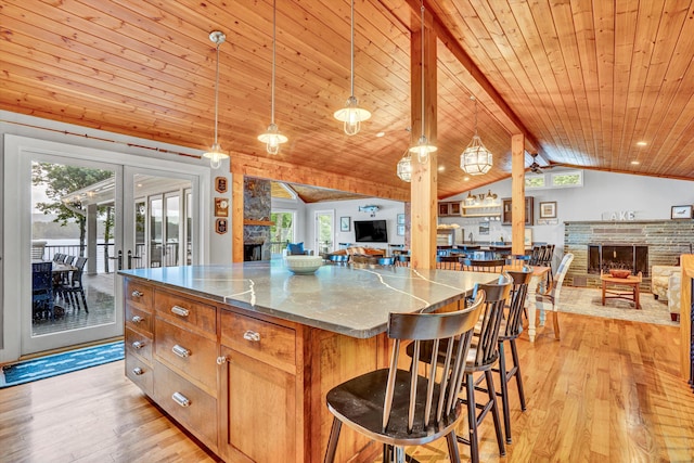511 Autumn Ave, Huddleston, VA 24104 - kitchen featuring a fireplace, open floor plan, light wood-style floors, a kitchen island, and wooden ceiling