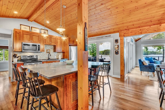 511 Autumn Ave, Huddleston, VA 24104 - kitchen with stainless steel appliances, a sink, light wood-style floors, decorative backsplash, and healthy amount of natural light