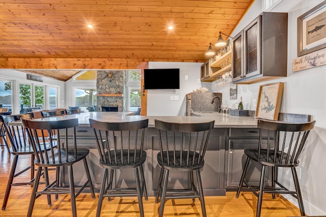 511 Autumn Ave, Huddleston, VA 24104 - kitchen with wooden ceiling, light wood-style flooring, a peninsula, a sink, and a kitchen breakfast bar