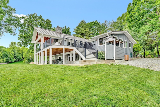 511 Autumn Ave, Huddleston, VA 24104 - rear view of house featuring a chimney, stairs, a wooden deck, a standing seam roof, and a yard