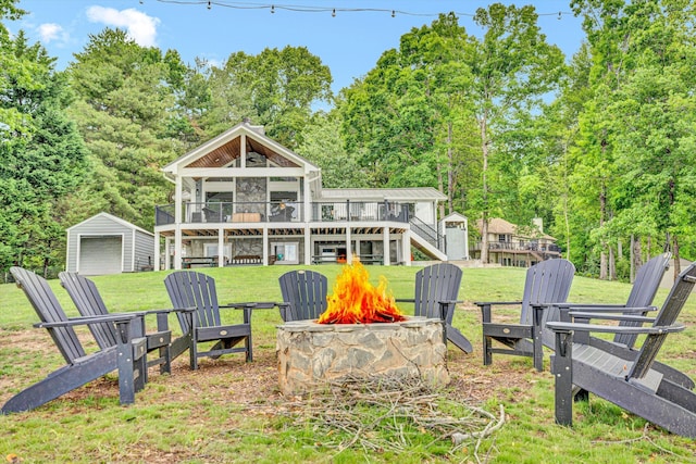 511 Autumn Ave, Huddleston, VA 24104 - rear view of property featuring a fire pit, a deck, stairway, a lawn, and a garage