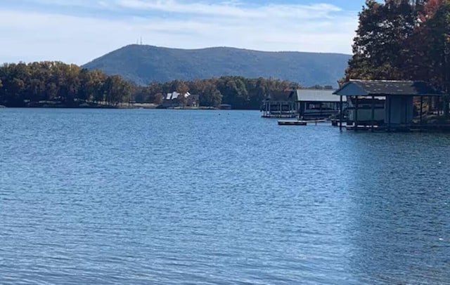 511 Autumn Ave, Huddleston, VA 24104 - water view with a boat dock and a mountainous background