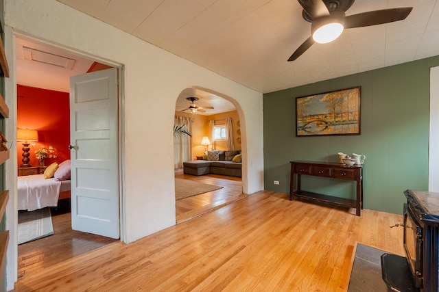 hall featuring arched walkways and wood finished floors