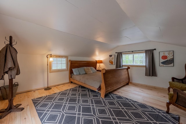 bedroom featuring hardwood / wood-style flooring and vaulted ceiling