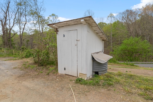 view of shed with a view of trees