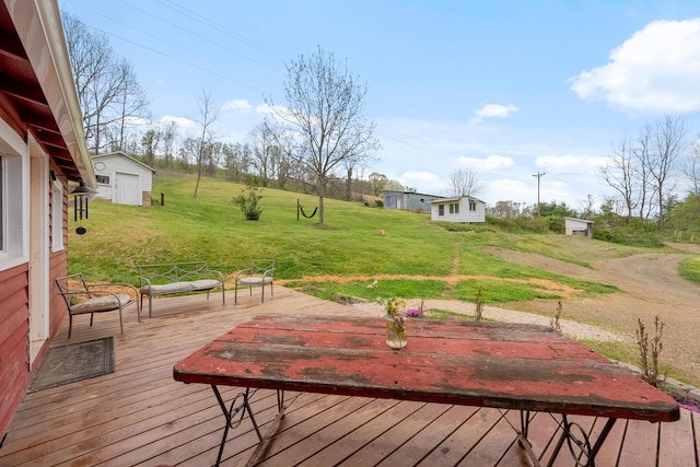 wooden deck with an outdoor structure, a shed, and a lawn
