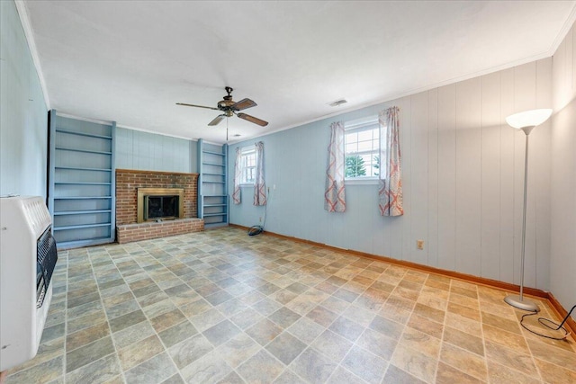unfurnished living room featuring crown molding, a ceiling fan, baseboards, heating unit, and visible vents