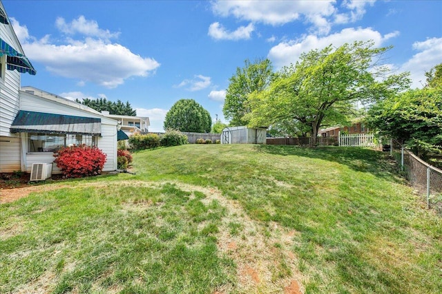 view of yard with a fenced backyard and an outbuilding