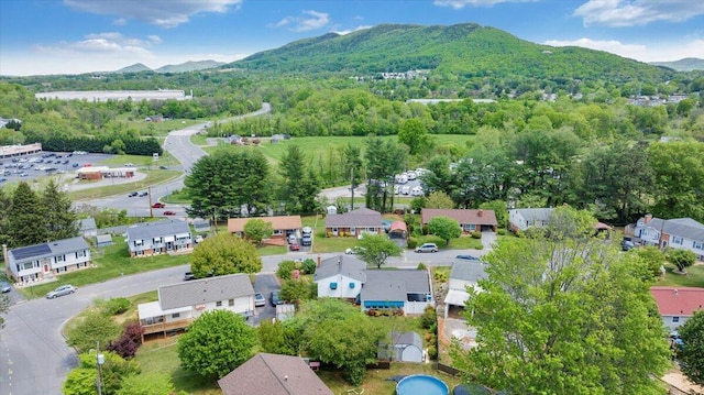 aerial view with a residential view, a mountain view, and a wooded view