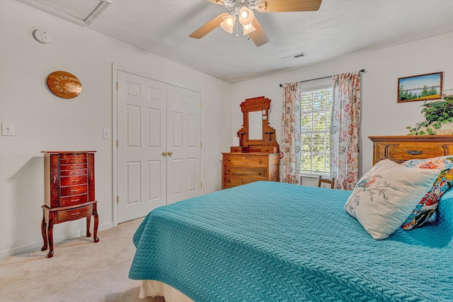bedroom with ceiling fan, visible vents, carpet, and a closet