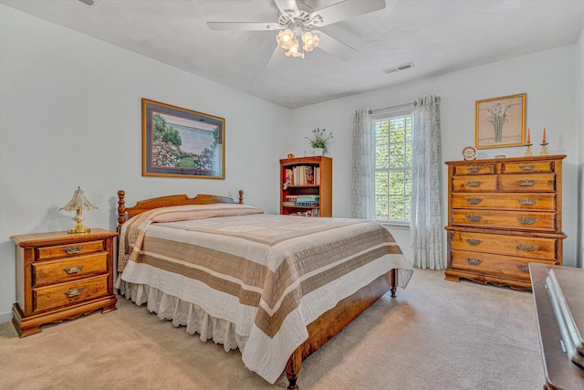 bedroom featuring ceiling fan, light carpet, and visible vents