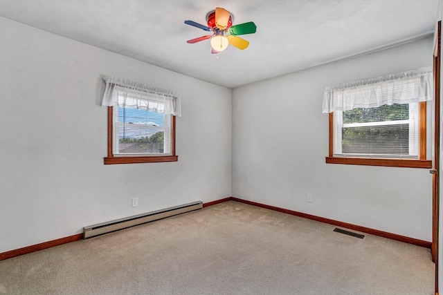 unfurnished room featuring baseboards, carpet flooring, baseboard heating, and a healthy amount of sunlight