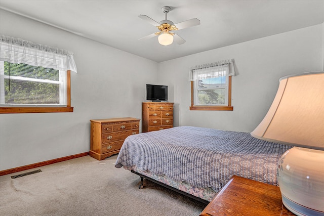 bedroom featuring baseboards, ceiling fan, carpet flooring, and visible vents