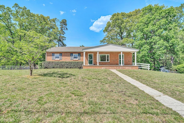 ranch-style house with fence, a front lawn, and brick siding