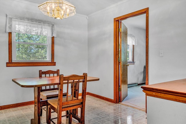 dining area with crown molding, a baseboard heating unit, baseboards, and a notable chandelier