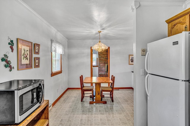 dining room featuring crown molding, baseboards, and a chandelier
