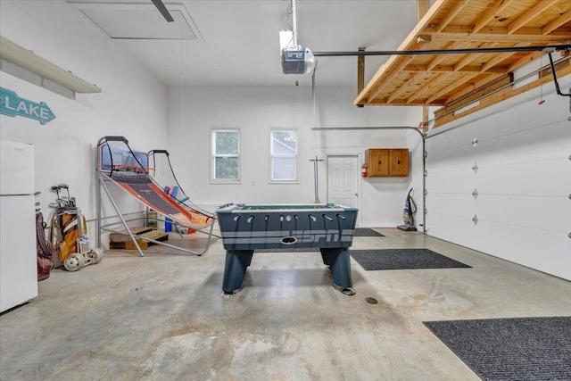 1165 Joffrey Dr, Huddleston, VA 24104 - garage with freestanding refrigerator and a garage door opener