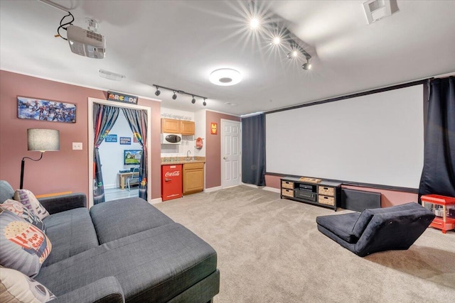 1165 Joffrey Dr, Huddleston, VA 24104 - home theater with track lighting, light colored carpet, a sink, and baseboards