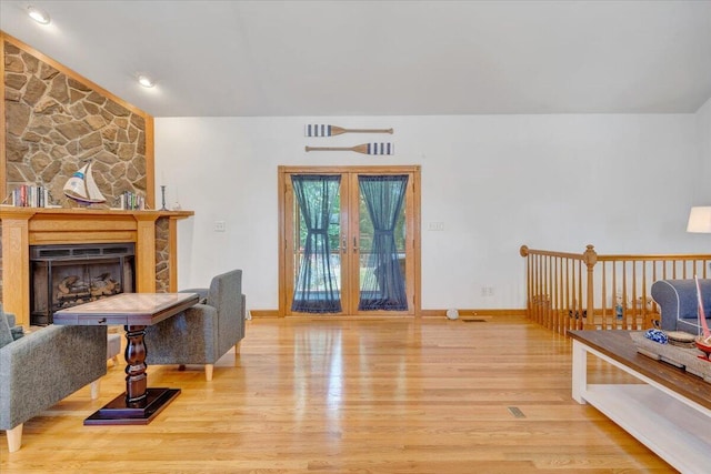 1165 Joffrey Dr, Huddleston, VA 24104 - living area featuring wood finished floors, a fireplace, baseboards, and vaulted ceiling