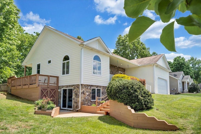 1165 Joffrey Dr, Huddleston, VA 24104 - rear view of house featuring a yard, stone siding, an attached garage, and a deck