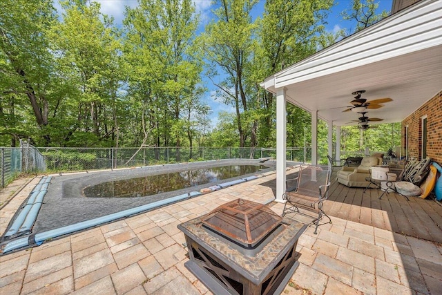 back of house with fence, an outdoor hangout area, a deck, an outdoor pool, and a chimney