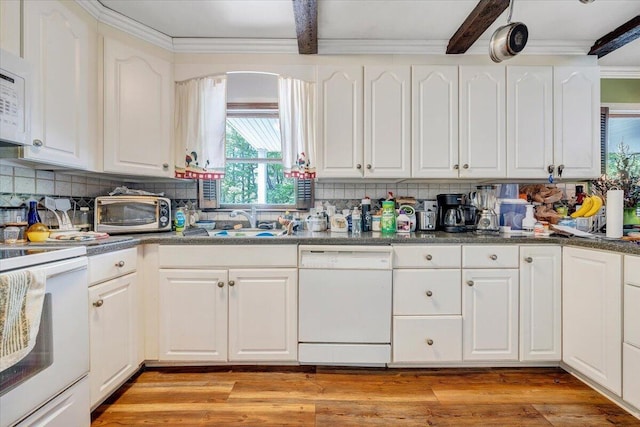 kitchen with white appliances and white cabinetry