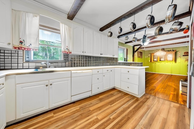 kitchen with white dishwasher, white cabinetry, beam ceiling, and light wood finished floors