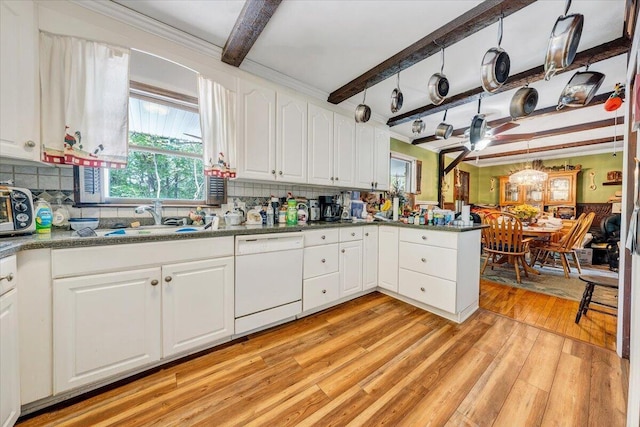 dining space featuring crown molding, beam ceiling, wood walls, a wainscoted wall, and light wood-type flooring