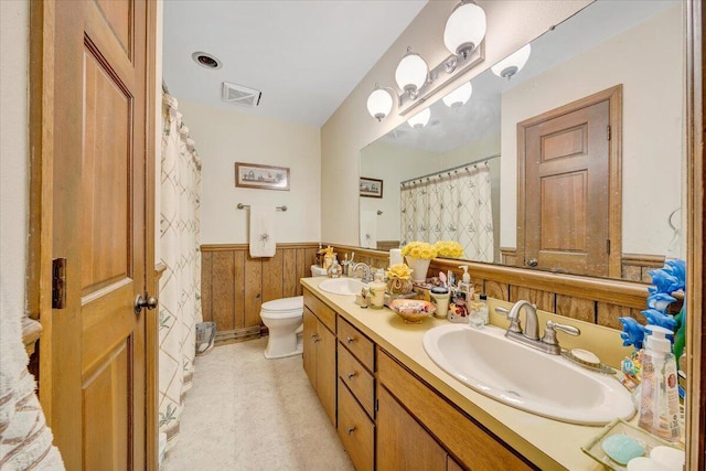 spare room with baseboards, ceiling fan, and a wealth of natural light
