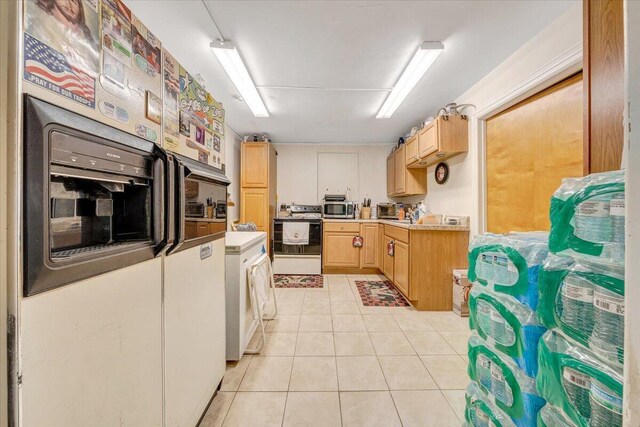 spare room with baseboards and light tile patterned floors