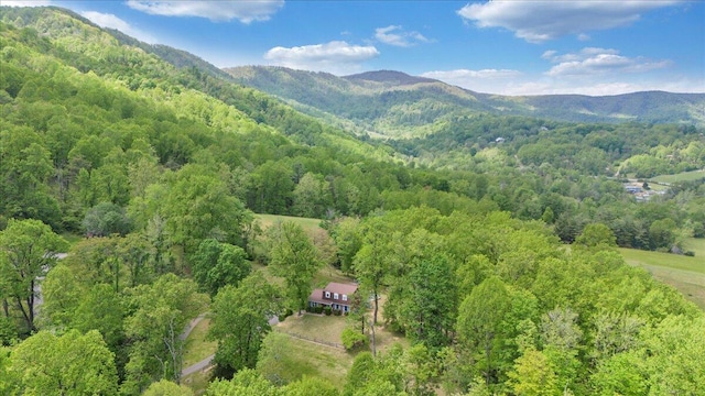 drone / aerial view featuring a forest view and a mountain view
