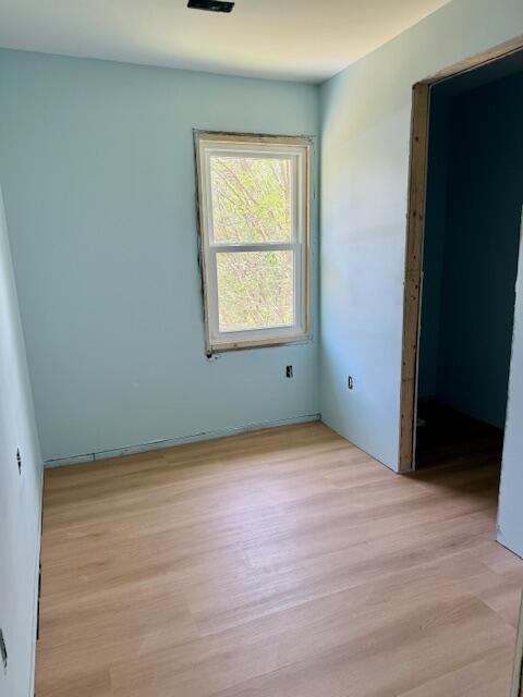 unfurnished bedroom with light wood finished floors