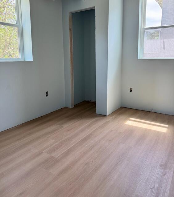 spare room with light wood-type flooring