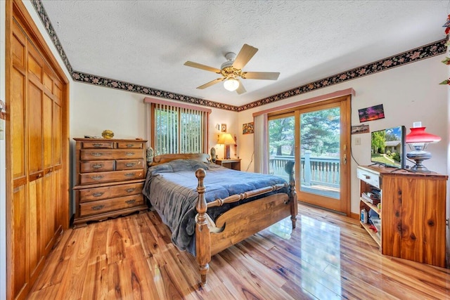 1296 Emerald Valley Way, Huddleston, VA 24104 - bedroom with access to exterior, light wood-type flooring, a textured ceiling, and a ceiling fan