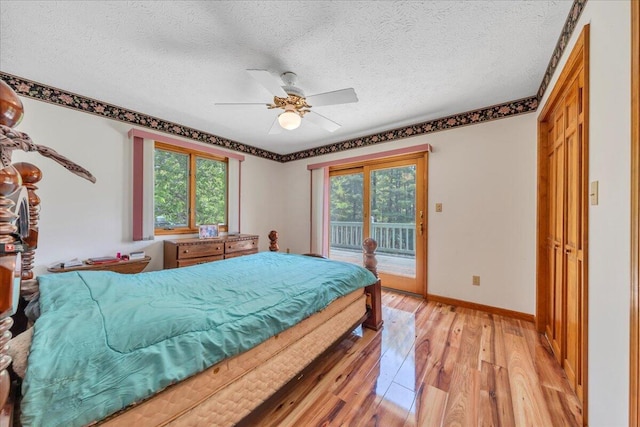 1296 Emerald Valley Way, Huddleston, VA 24104 - bedroom with light wood-type flooring, access to exterior, multiple windows, baseboards, and a textured ceiling