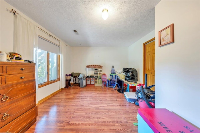1296 Emerald Valley Way, Huddleston, VA 24104 - playroom with a textured ceiling and light wood-style flooring