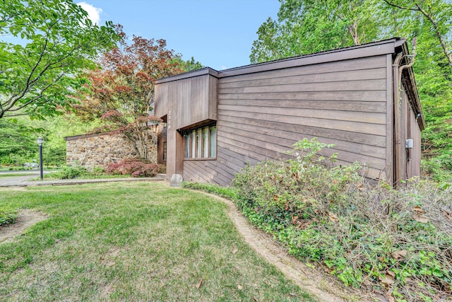 view of side of home featuring a lawn