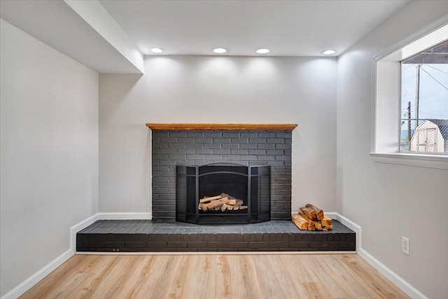 interior details featuring baseboards, recessed lighting, wood finished floors, and a fireplace