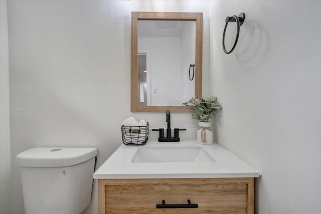 half bath with vanity and toilet