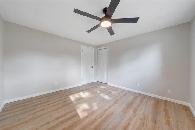 unfurnished room featuring baseboards, ceiling fan, and light wood-type flooring