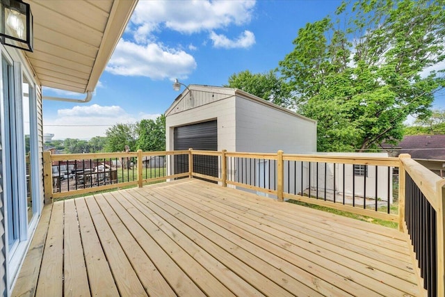wooden deck with an outbuilding and a garage