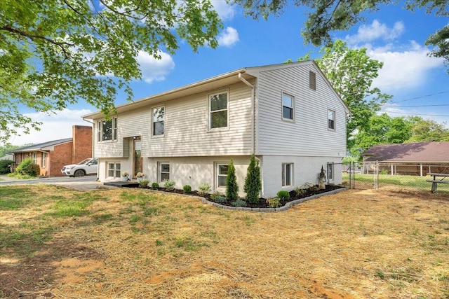view of front of property with a front lawn and fence