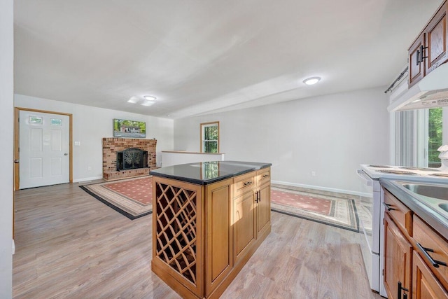 kitchen featuring baseboards, dark countertops, white electric range, and light wood-style floors